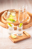 Boardwalk round trays with glasses and a pitcher. 