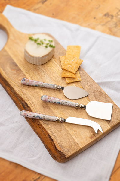Darcy enamel cheese tools on a cutting board