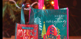 Merry Everything Holiday Recycled Gift Bags in front of a Christmas Tree