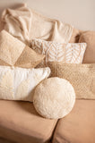 White Round Jute Pillow on a couch