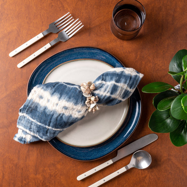 High Tide Tie Dye Dinner Napkins on a table