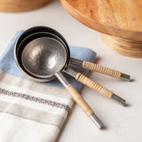 Catalina Cane Wrapped Measuring Cups on a tea towel