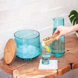 Teal Catalina Ice Bucket With Raffia Tongs on a table