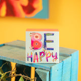 Be happy wood block sign on a table