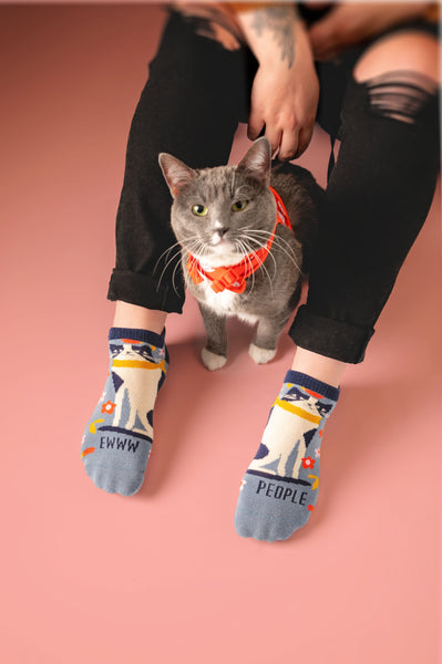 A cat by their owner wearing cat ankle socks