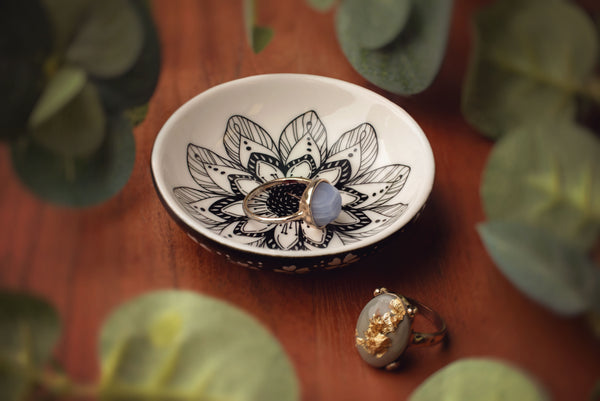 Flower boho ring bowl with rings and a table