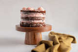 Natural wood cake stand with a cake 