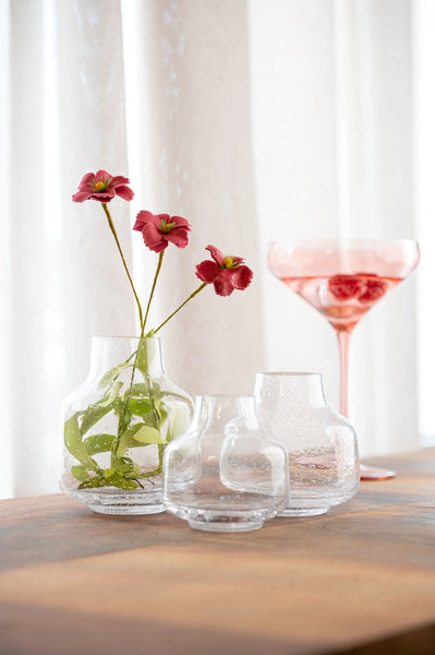 Clear bubble glass vase's holding flowers 