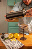 Silver Cocktail Shaker pouring into a glass. 