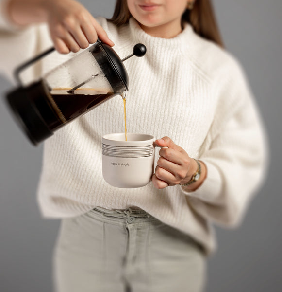 Woman pouring coffee in keep it simple milo mug