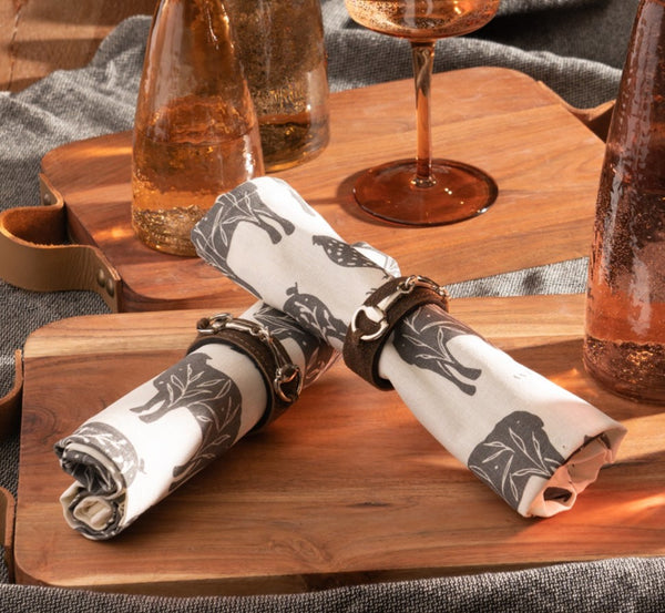 Buckled leather napkin rings on napkins