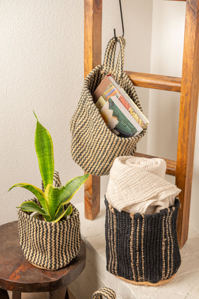 Vertical stripe woven basket set carrying a blanket