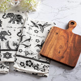 Boho tea towels with cutting board on a counter