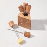 Wood cheese picks on a counter.