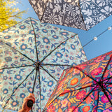 Travel umbrellas outside and stacked around each other.