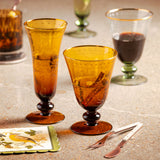 Honey gold etched flute and wine glassware on a table 
