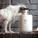 Dog eating out of good dog milo canister