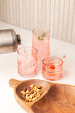 Blush Mid Century Cooler Glasse on a table with other blush glasses