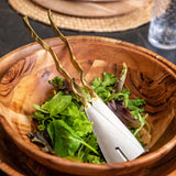 Branch salad servers in a salad bowl